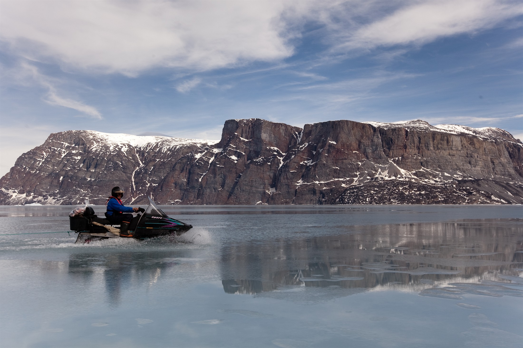 Snow mobile travel over sea ice in Uummannaq, Greenland